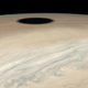 Io’s shadow as it appears near Jupiter’s horizon.